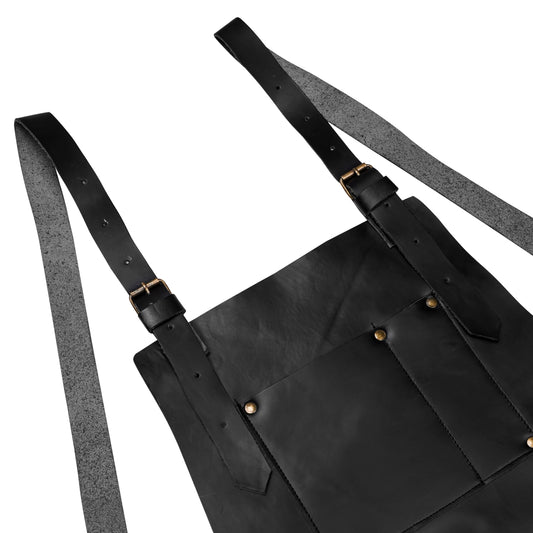 Premium handcrafted leather apron made from full-grain cowhide, featuring adjustable leather straps, brass hardware, and multiple storage pockets. Ideal for use by BBQ chefs, hairstylists, butchers, handymen, and blacksmiths. Designed for durability and comfort. Makes a perfect personalized gift for men, professionals, or Father’s Day.