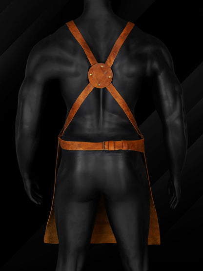 Back view of a man wearing a brown leather work apron with reinforced straps