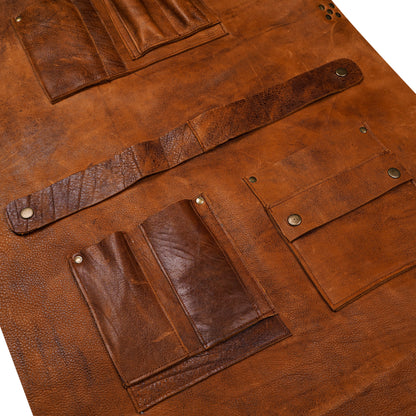 Close-up detail of high-quality leather texture and utility pockets on workshop apron