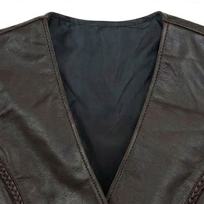 Close-up of the V-neck collar and snap button front closure on a women's dark brown leather biker vest