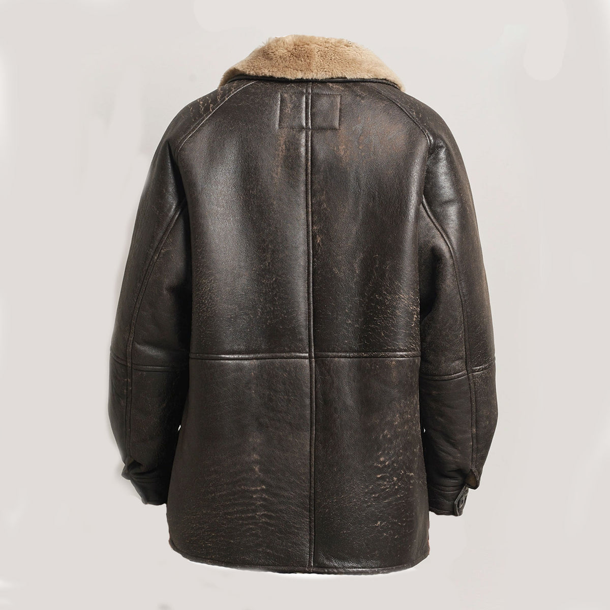Back view of vintage cowhide leather shearling winter jacket showing the rich dark-brown leather exterior, structured back panel, full faux-fur lining construction, and classic rugged aviator-inspired winter design