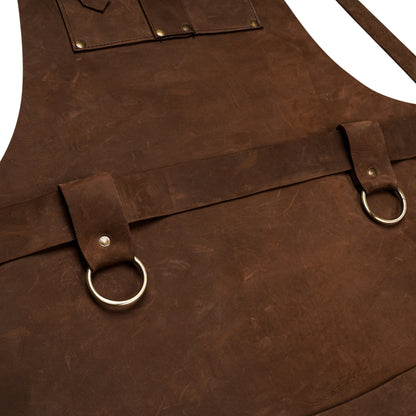 Heavy-duty brass buckles and towel rings on leather apron.