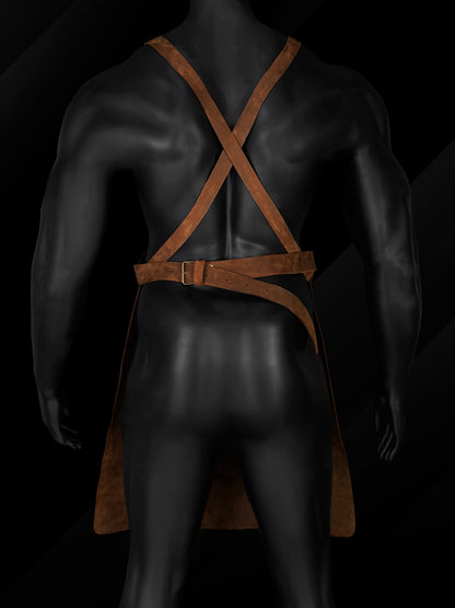 Adjustable cross back straps on leather barbecue apron.