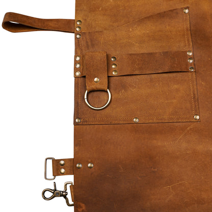 Close-up of reinforced pockets and brass rings on leather apron.
