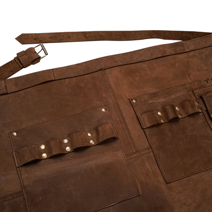 Close up of tool pockets on leather half apron.