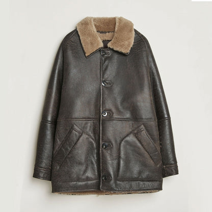 Front view of vintage brown cowhide leather shearling winter jacket with plush faux-fur collar, button-front closure, structured silhouette, and two angled front pockets displayed against a clean studio background